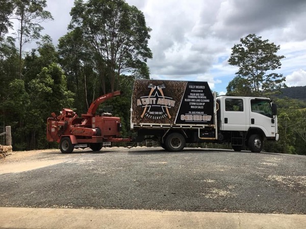 The truck and chipper set up on a gravel drive