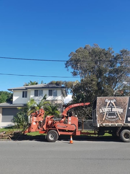 The chipper and truck working a street-side job